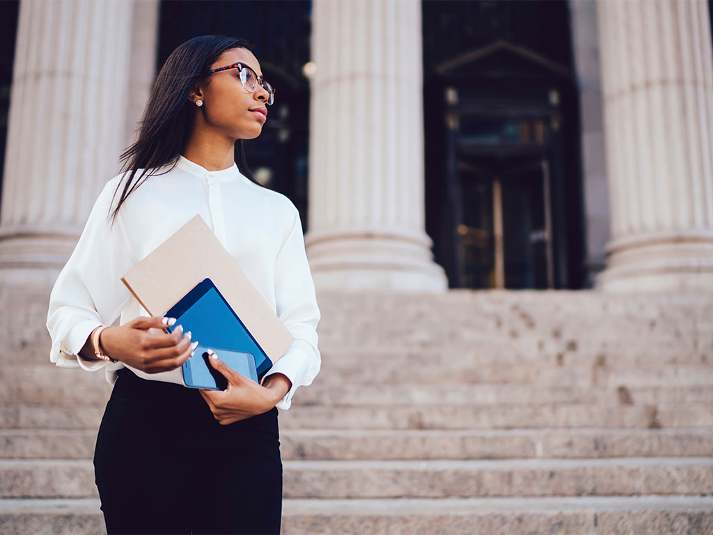 African lady standing in front of a court house